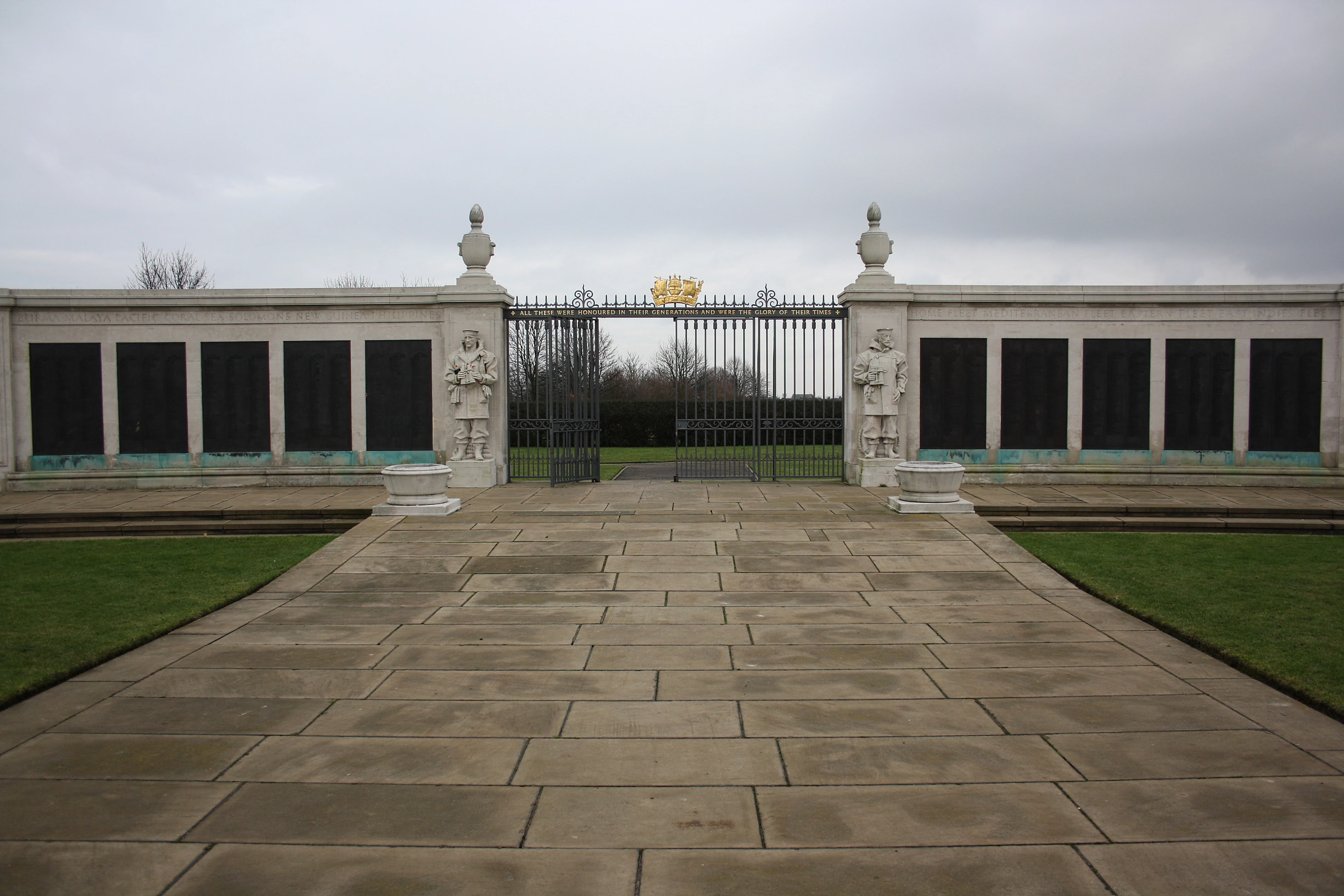 The gates viewed from inside the memorial, inscribed 'All these were honoured in their generations and were the glory of their times'. The plaques extending from the gate commemorate those who died in the Second World War.